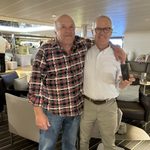 two friends with arms over each others shoulders