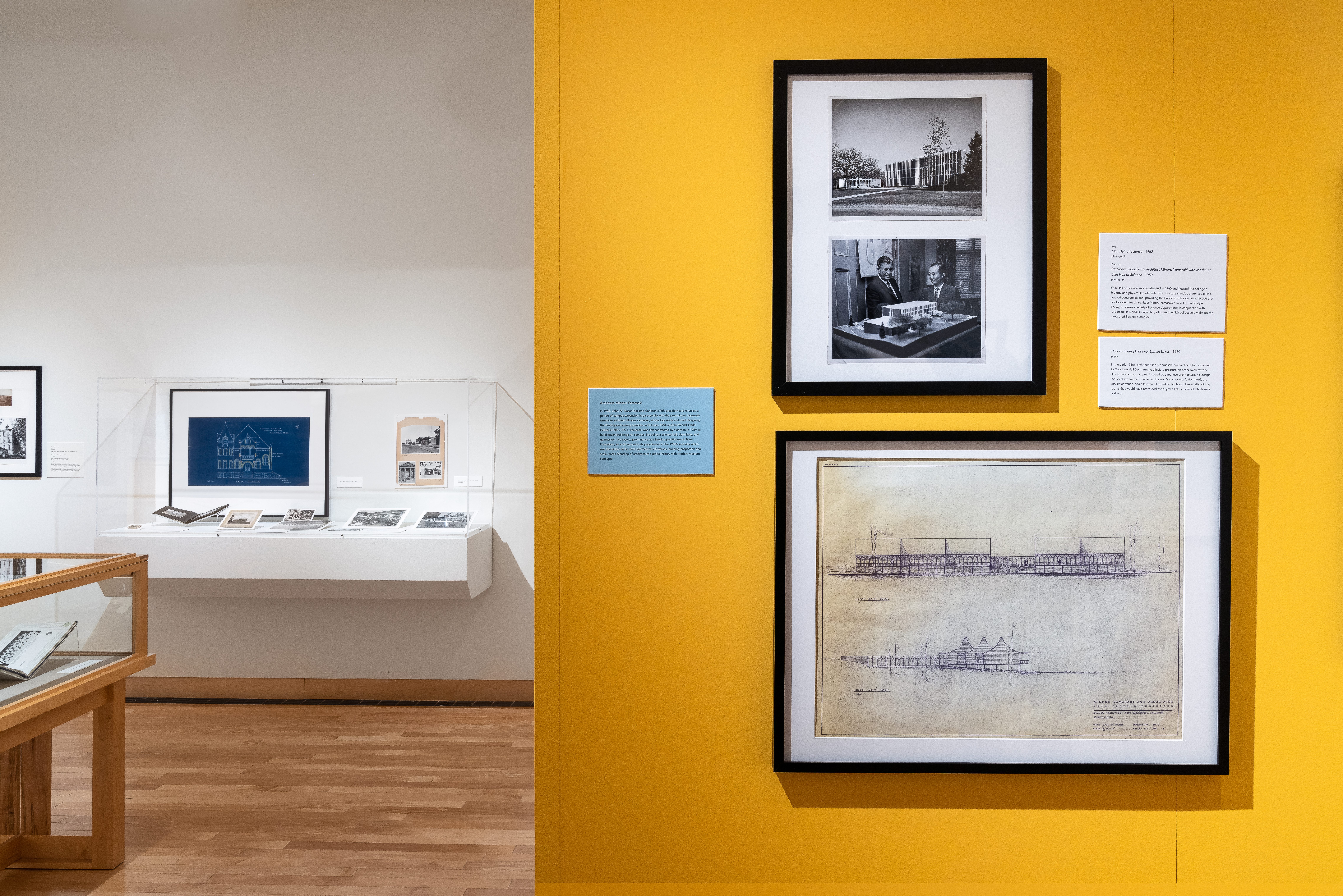 Detail of images of architect Minoru Yamasaki’s work on central wall in front of other objects and pictures on the back wall