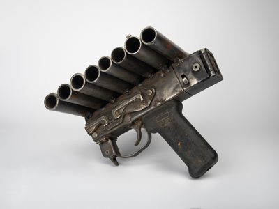 Metal sculpture of a handgun converted into a pan flute