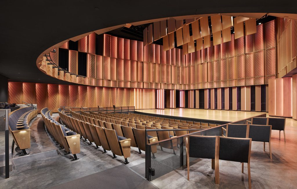 View of the Kracum Performance Hall lower level seating, stage, and ceiling.