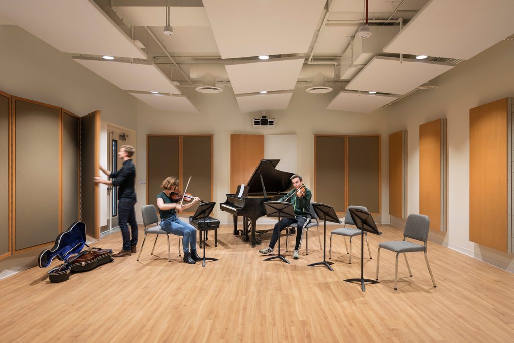 Student violinists and cellist rehearse in Puzak Chamber Studio in the Weitz Center for Creativity.