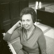 black and white photo of Anne Mayer at the keyboard