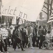 Students march with a Carleton banner