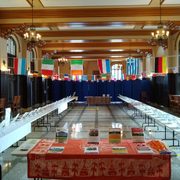 empty room filled with information tables and flags from many countries