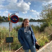 Becca posing infornt of the sign noma