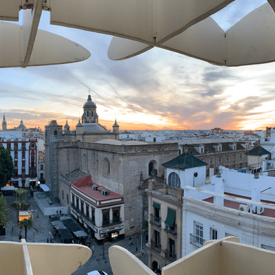 A wide shot of a city skyline through the Setas de Sevilla