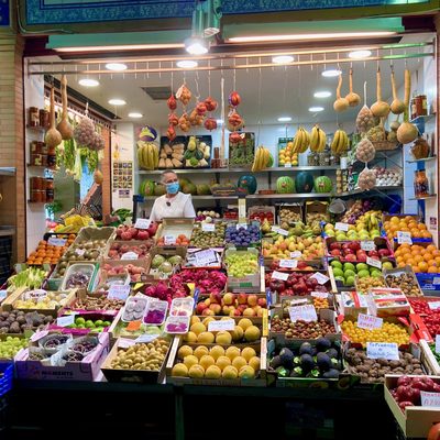 A Spanish market stall filled with colorful fruits and vegetables