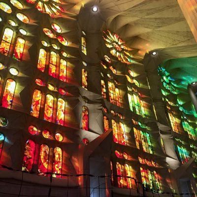 Stained glass church windows glowing rainbow in the Sagrada Familia