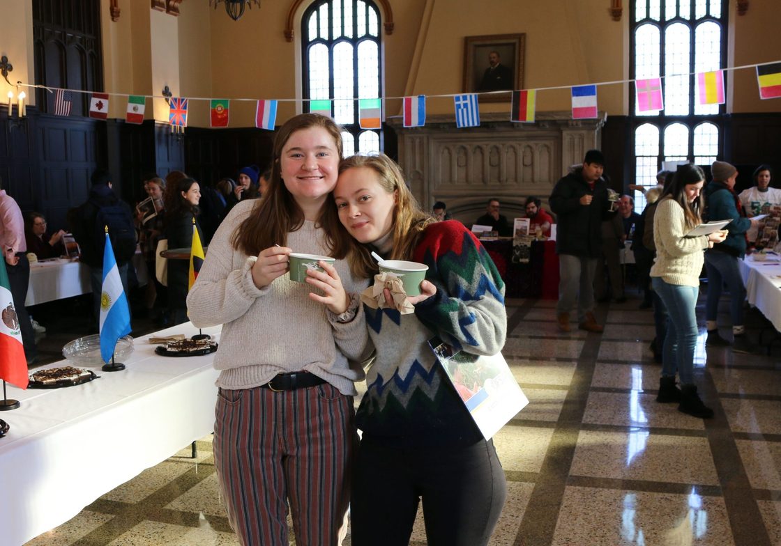 students pose with food at World Fair 2020