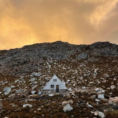 A small cabin nestled in a mountainside