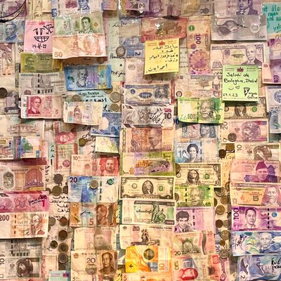 A wall covered in money from different countries