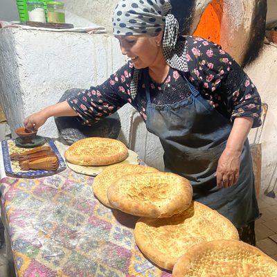 A woman baking Tandoor Lepeshka bread