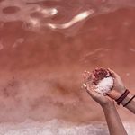 Taken at a salt mining site in Namibia, this photograph documents a landscape shaped by ongoing salt extraction and its pink waters