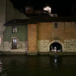 two old ladies conversing under a secret passage by the river.