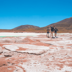 three students standing in the desert