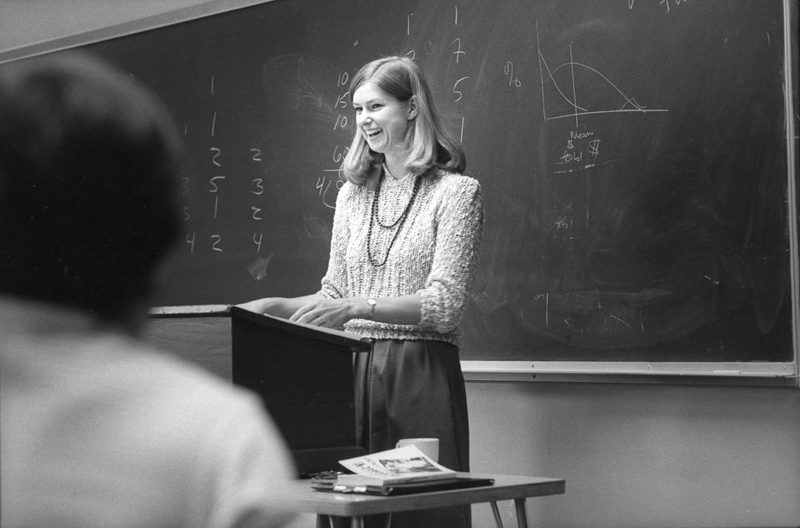 Bev in front of a blackboard