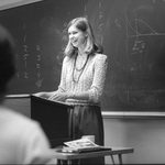 Bev in front of a blackboard