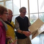 Attendees at art installation read the project documentation