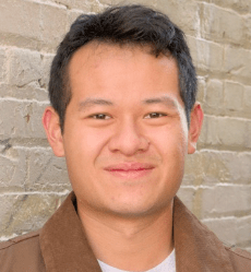Young Asian man, short dark hair, wearing white t-shirt and brown suede jacket