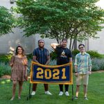The Senior Banquet speakers and their introducers stand behind the maize and blue class banner, which reads 