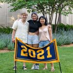 Three members of the Class of 2021 stand behind the maize and blue class banner, which reads 