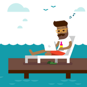 Man using a laptop by a lake