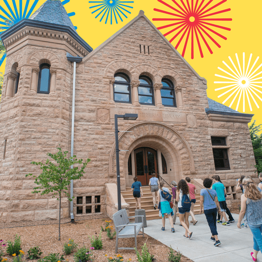 A group of people walk past Scoville Hall on a campus tour