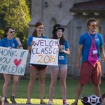 Enthusiastic greeters welcome new students to campus