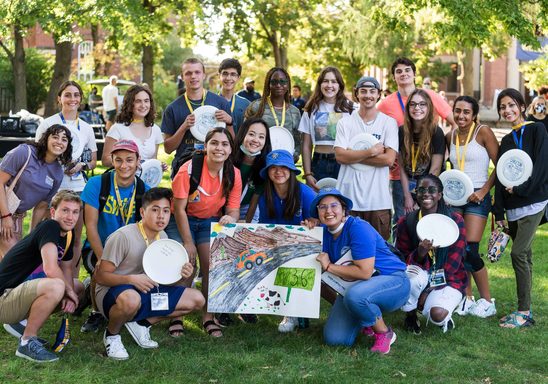 A large group of students holding Frisbees