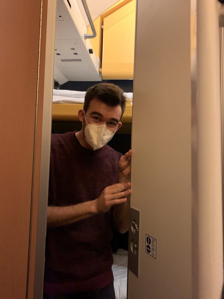 Joey peeking through the secret door between our compartments