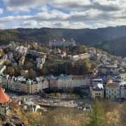 Renaissance-style buildings in Karlovy Vary stretch across an autumn valley.