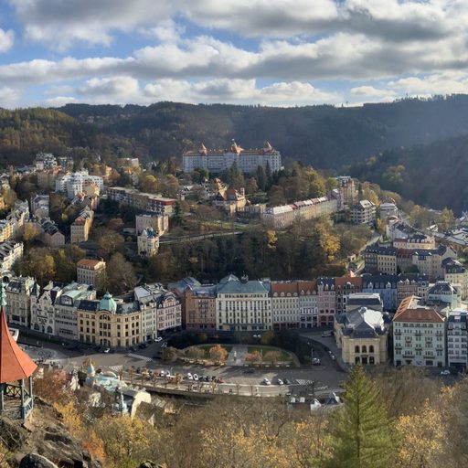 Renaissance-style buildings in Karlovy Vary stretch across an autumn valley.