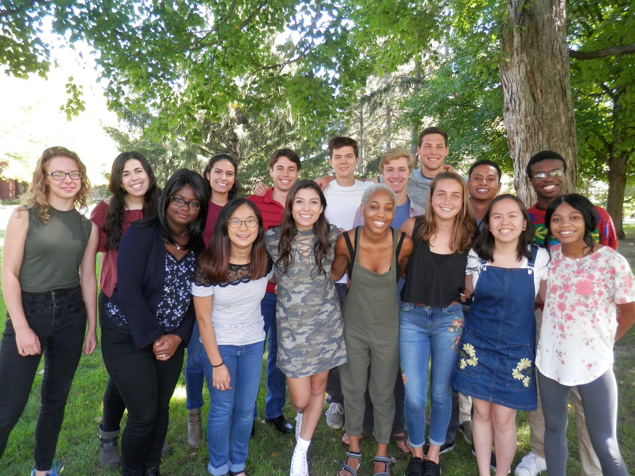 A group of students posing under a tree