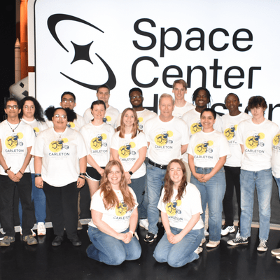 Group of students and staff in front of the Space Center Houston sign