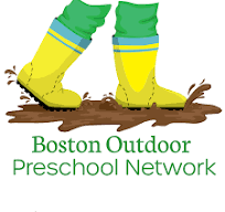 Kids feet with rubber boots walking in the mud
