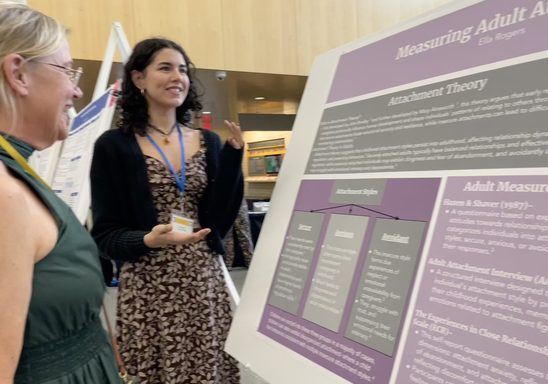 Julie and Ella presenting a poster