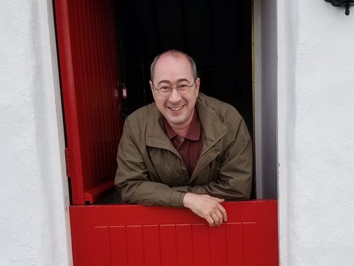 Pierre Hecker looks out of an Irish cottage doorway
