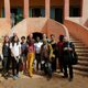 group picture of students in front of pink building in senegal