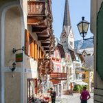 street view of town n austria with church steeple in background