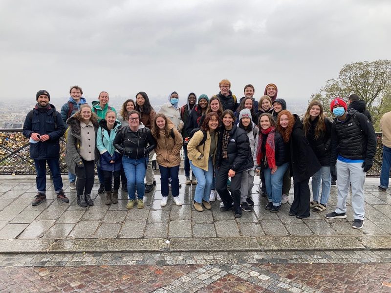 group of students psoing on a rainy day