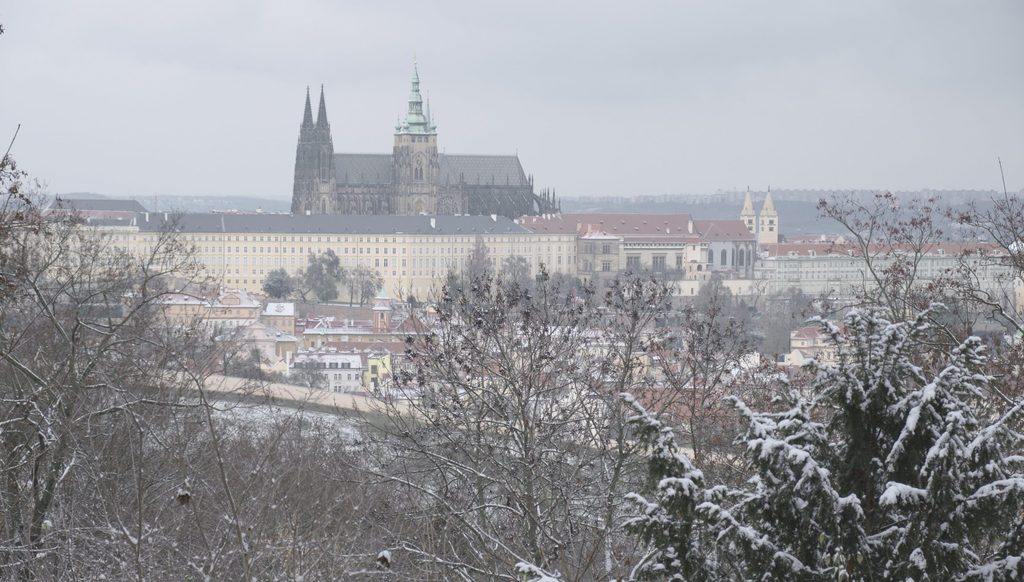 snowy dawn in prague with a view of prague castle