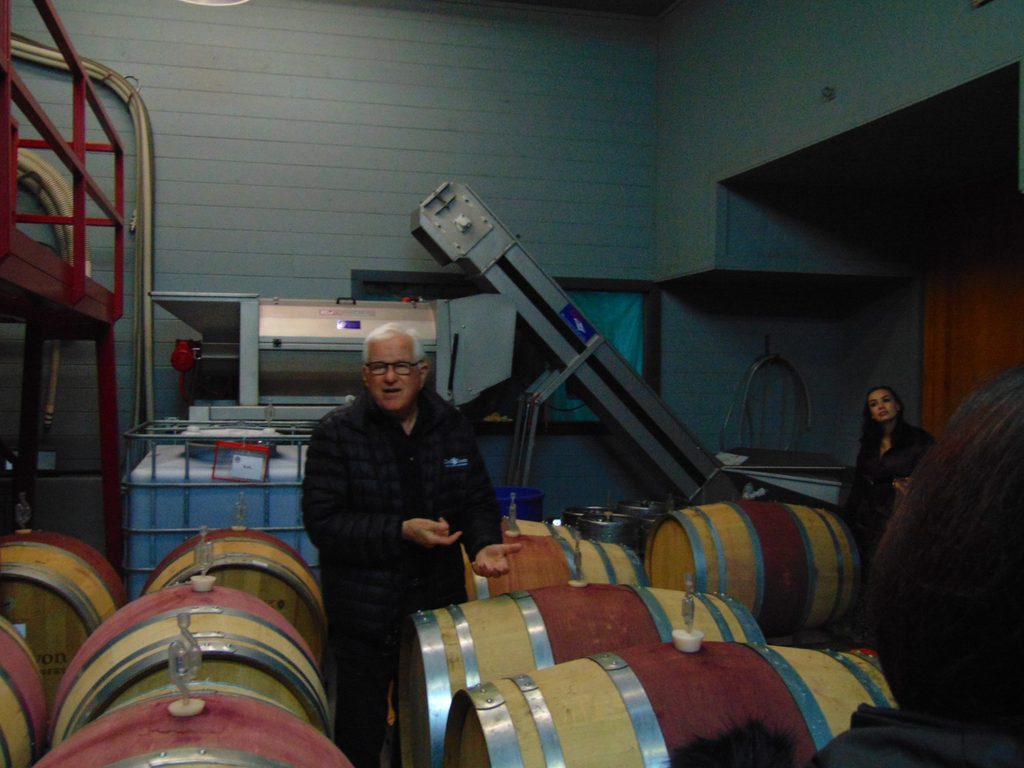 professor surrounded by barrels