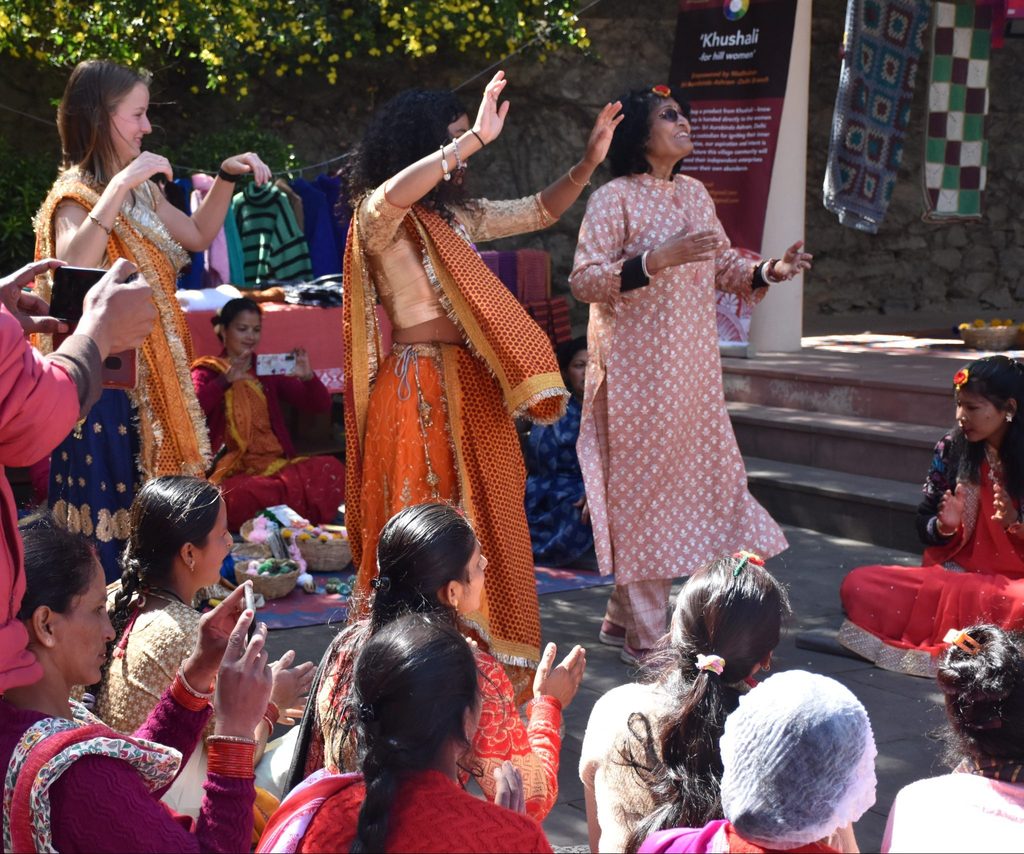 three women dancing at the crafts fair