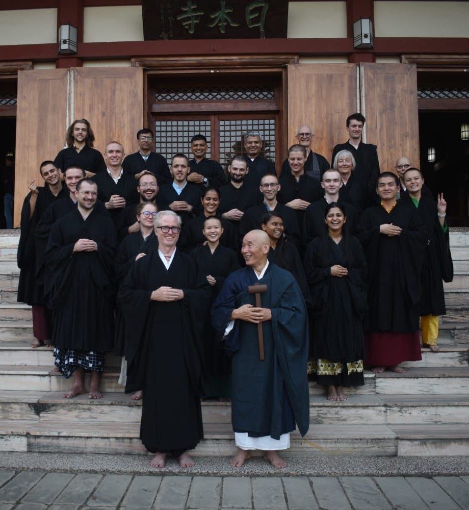 students stand in black robes