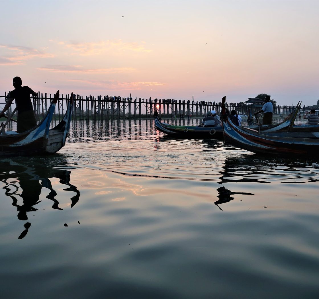 people in boats at dusk