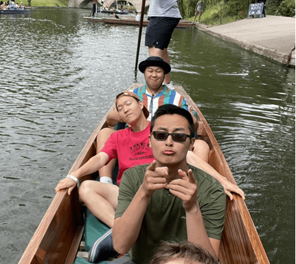 students ride boat on River Cam