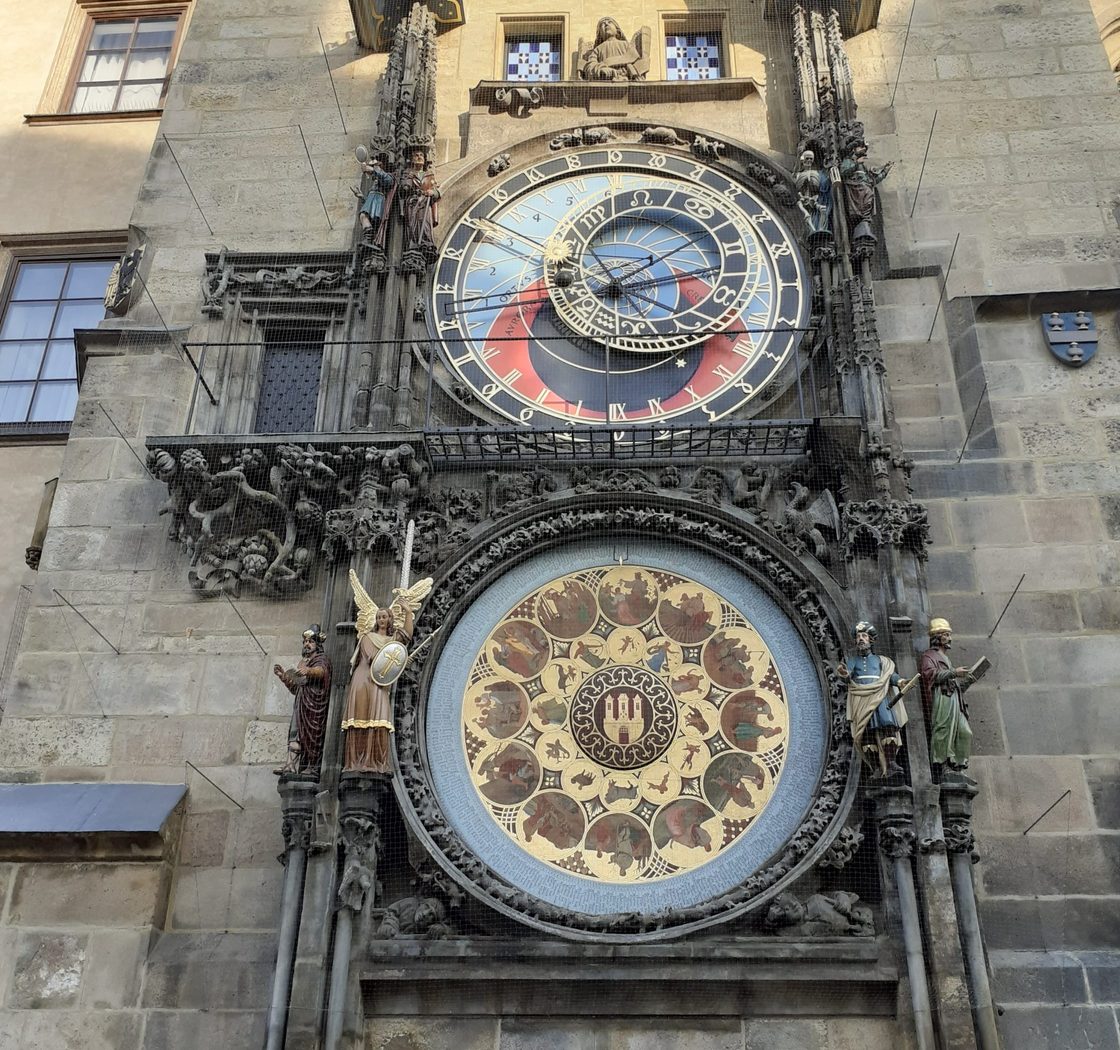 ornate clocks on the side of a stone building