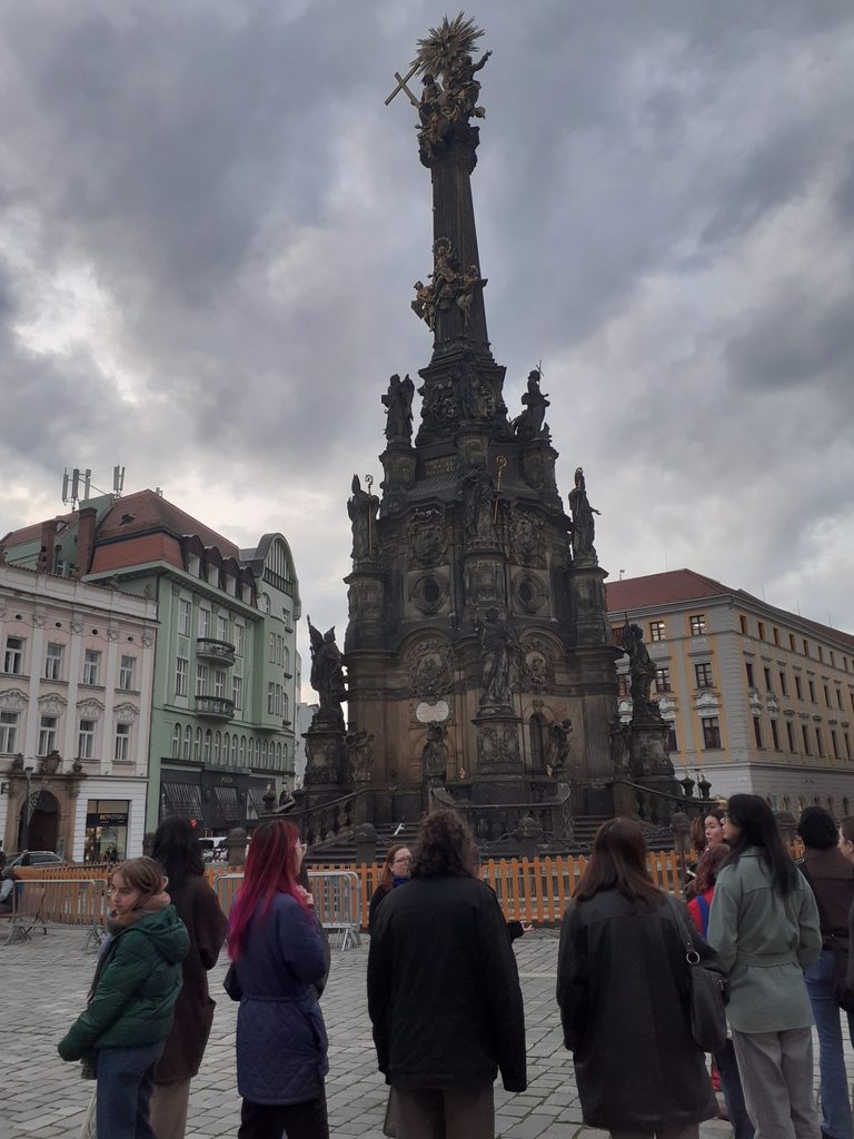 students observe historic sculpture