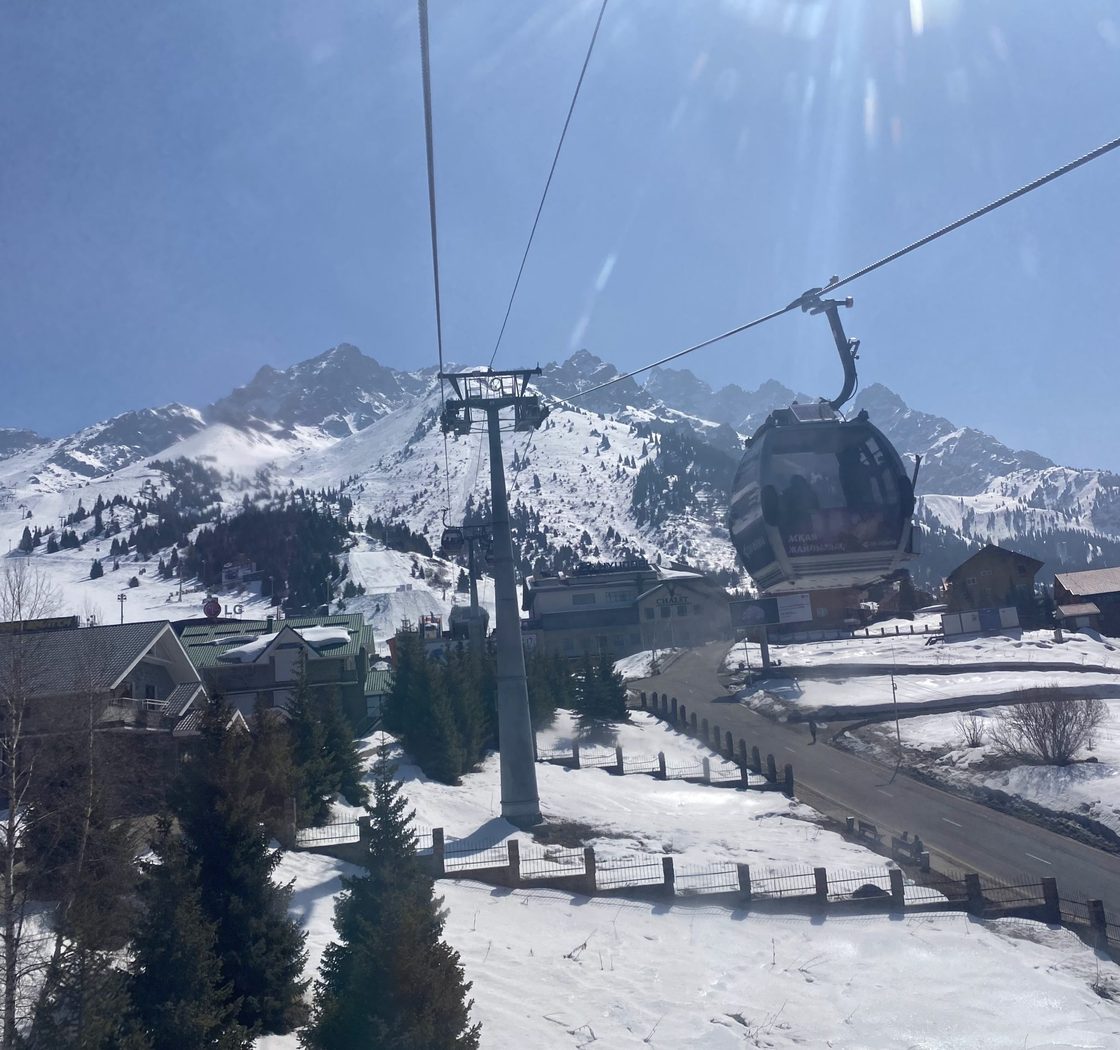 students ride ski lift up mountain