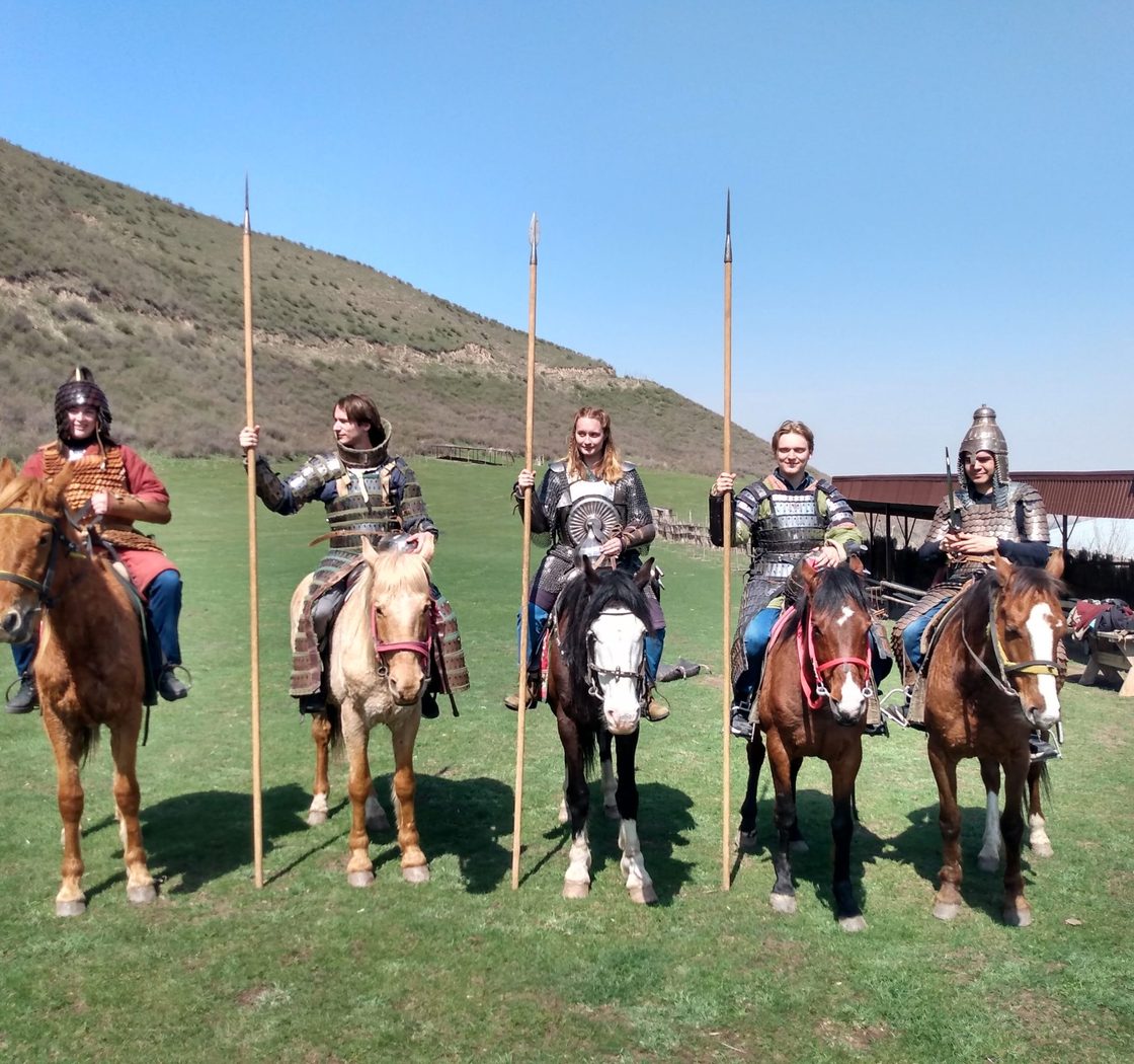 students wear garb of knights on horseback